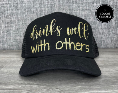 Drinks well with others Trucker Hat
